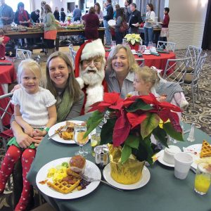 Santa with a family at Santa Brunch